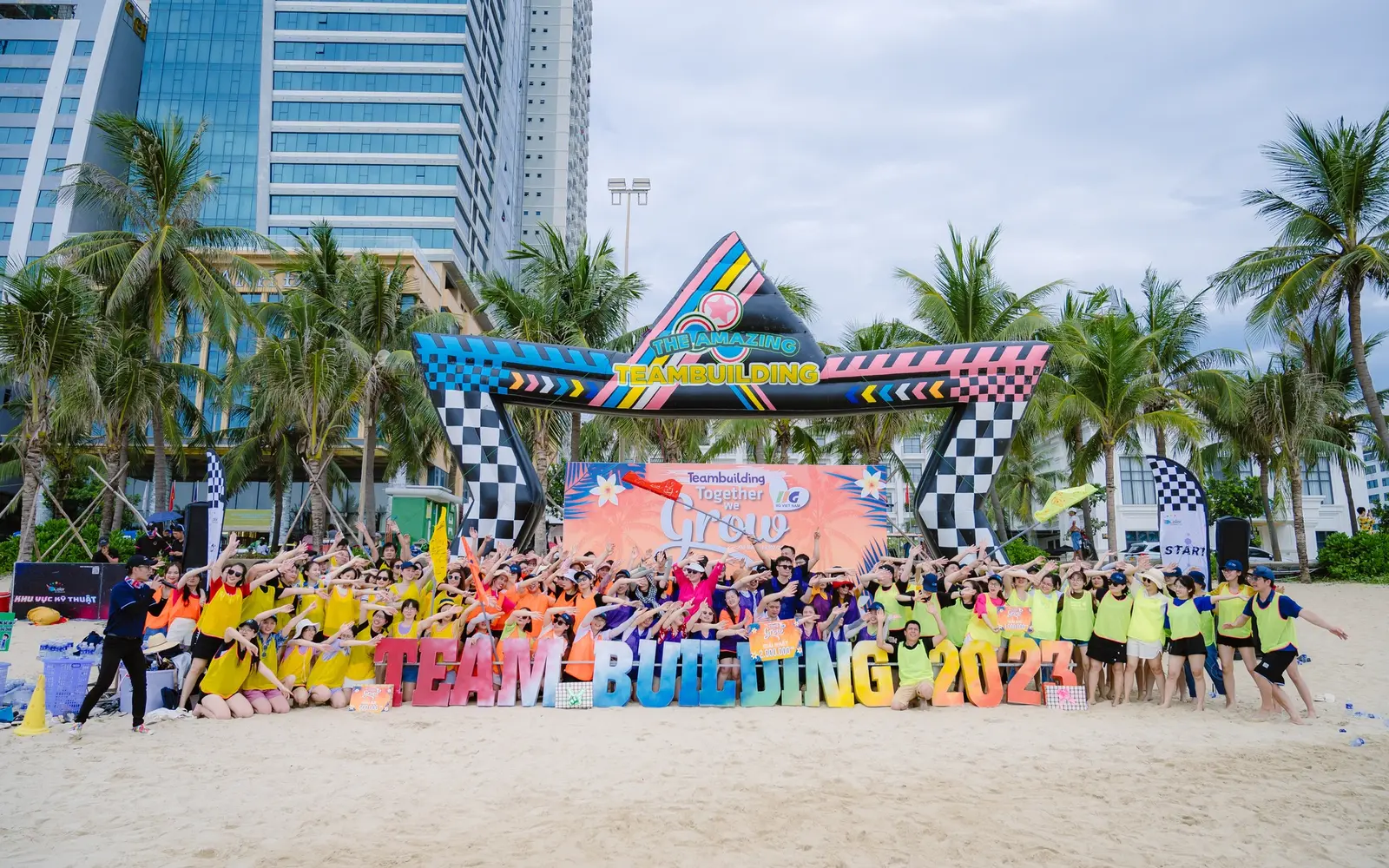 The IIG Vietnam team posing together on a beach during the 2023 team-building programme